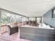 Covered patio with wicker furniture, wood floors, and a view of the backyard at 11335 Mcmullen Loop, Riverview, FL 33569
