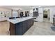 Open kitchen showcasing a large island, stainless steel appliances, and seamless flow to the laundry at 11335 Mcmullen Loop, Riverview, FL 33569