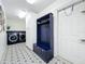 Well-organized laundry room with washer, dryer, cabinet and coat rack at 11335 Mcmullen Loop, Riverview, FL 33569
