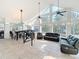 Open-concept living room with vaulted ceilings, large windows, tile flooring, and stylish furniture at 11335 Mcmullen Loop, Riverview, FL 33569