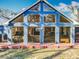 Blue home with a deck, large windows, and a spacious backyard at 11335 Mcmullen Loop, Riverview, FL 33569