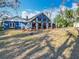Wide backyard view of a blue house, a patio, and an outdoor shed at 11335 Mcmullen Loop, Riverview, FL 33569