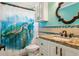 Bathroom with granite countertop, decorative mirror, and sea turtle shower curtain at 11970 80Th Ave, Seminole, FL 33772