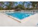 The beautiful community pool is surrounded by tropical landscaping with plenty of seating for residents at 120 Kay Ct, Oldsmar, FL 34677