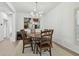 Modern dining room with a unique round table, six chairs, and a stylish chandelier, perfect for entertaining at 12037 Mountbatten Dr, Tampa, FL 33626