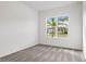 Bright bedroom with neutral-toned walls and plush carpeting, overlooking a street view at 12652 Glenn Creek Dr, Riverview, FL 33569