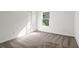 Cozy bedroom with plush carpeting, bright walls, and natural light from the window at 12652 Glenn Creek Dr, Riverview, FL 33569