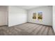 A bright bedroom with large windows and neutral gray carpeting at 12652 Glenn Creek Dr, Riverview, FL 33569