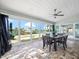 Sun room featuring tile flooring, ceiling fan, and floor to ceiling sliding glass doors overlooking the water at 16125 4Th E St, Redington Beach, FL 33708