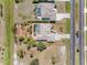 A top-down view of two homes with screened pools and neat landscaping at 182 Rotonda N Blvd, Rotonda West, FL 33947