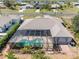 Aerial view of the home with a screened lanai, swimming pool, and mature landscaping at 182 Rotonda N Blvd, Rotonda West, FL 33947