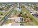 Expansive aerial view of a residential area featuring well-maintained homes, green spaces, and a long, straight road at 182 Rotonda N Blvd, Rotonda West, FL 33947