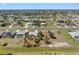 Sweeping aerial perspective of a sprawling residential community featuring uniform homes, orderly streets, and green lawns at 182 Rotonda N Blvd, Rotonda West, FL 33947