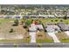 Aerial view of a well-maintained single-story home with a private pool, landscaped backyard, and spacious driveway at 182 Rotonda N Blvd, Rotonda West, FL 33947