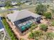 Aerial view showcasing the backyard with a screened pool and lush landscaping at 182 Rotonda N Blvd, Rotonda West, FL 33947