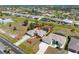 Overhead view of a charming single-story home featuring a pool, spacious yard, and a long driveway in a quiet neighborhood at 182 Rotonda N Blvd, Rotonda West, FL 33947