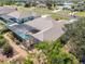 Aerial view of a house with a screened pool and a well-manicured yard in a residential area at 182 Rotonda N Blvd, Rotonda West, FL 33947