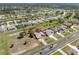 An aerial view of a home with a pool and a large lot in a residential neighborhood at 182 Rotonda N Blvd, Rotonda West, FL 33947