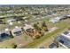 Vast aerial shot of a suburban neighborhood showcasing neatly arranged homes, streets, and open spaces on a sunny day at 182 Rotonda N Blvd, Rotonda West, FL 33947