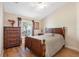 Bedroom features a bed, a dresser, a window, and hardwood floors at 182 Rotonda N Blvd, Rotonda West, FL 33947