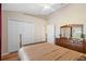 Neutral bedroom features hardwood floors, closet, ceiling fan and a wooden dresser at 182 Rotonda N Blvd, Rotonda West, FL 33947