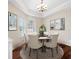 Bright dining room features modern lighting, round dining table, and hardwood flooring at 182 Rotonda N Blvd, Rotonda West, FL 33947