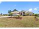 Beautiful one-story home featuring a well-kept lawn with palm trees, a spacious driveway, and an attached two-car garage at 182 Rotonda N Blvd, Rotonda West, FL 33947