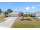 Charming single-story home with a three-car garage and lush, tropical landscaping at 182 Rotonda N Blvd, Rotonda West, FL 33947