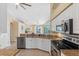 Updated kitchen features granite countertops, stainless steel appliances, and white cabinetry at 182 Rotonda N Blvd, Rotonda West, FL 33947
