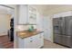 Kitchen area features stainless steel refrigerator, granite countertops, and modern white cabinetry at 182 Rotonda N Blvd, Rotonda West, FL 33947