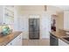Kitchen area features stainless steel refrigerator, granite countertops, and modern white cabinetry at 182 Rotonda N Blvd, Rotonda West, FL 33947