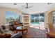 Comfortable living room with wood floors, vaulted ceiling, and views of the screened pool, creating a serene space at 182 Rotonda N Blvd, Rotonda West, FL 33947