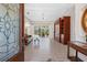 Bright living room with tile flooring, a ceiling fan, and views of the screened lanai and pool area at 182 Rotonda N Blvd, Rotonda West, FL 33947