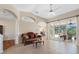 Open living room with tile flooring and access to the screened lanai, seamlessly blending indoor and outdoor living at 182 Rotonda N Blvd, Rotonda West, FL 33947