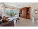 Bright living room with tile floors offering a view of the screened pool, creating a spacious and open atmosphere at 182 Rotonda N Blvd, Rotonda West, FL 33947