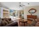 Cozy living room with wood floors and a view of the screened pool, perfect for entertaining guests and relaxation at 182 Rotonda N Blvd, Rotonda West, FL 33947