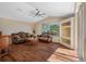 Comfortable living room featuring wood floors, vaulted ceiling, and large windows providing natural light at 182 Rotonda N Blvd, Rotonda West, FL 33947