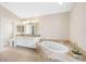 Bright main bathroom features tile floors, double sink vanity, and a large soaking tub at 182 Rotonda N Blvd, Rotonda West, FL 33947