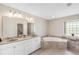 Bright main bathroom features tile floors, double sink vanity, and a soaking tub at 182 Rotonda N Blvd, Rotonda West, FL 33947