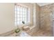 Bright main bathroom features tile floors, natural light, and a shower at 182 Rotonda N Blvd, Rotonda West, FL 33947