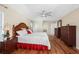 Bright main bedroom features wood floors, ceiling fan, and dual dressers at 182 Rotonda N Blvd, Rotonda West, FL 33947