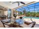Enclosed patio featuring an outdoor dining table, ceiling fan and view of the pool at 182 Rotonda N Blvd, Rotonda West, FL 33947
