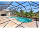 Inviting screened-in pool with stone patio, surrounded by lush tropical landscaping, perfect for relaxation at 182 Rotonda N Blvd, Rotonda West, FL 33947