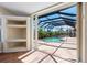 View of enclosed pool and patio through sliding glass doors in a naturally lit room at 182 Rotonda N Blvd, Rotonda West, FL 33947