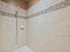 Close up of the walk-in shower featuring a decorative tile accent at 18620 Cortes Creek Blvd, Spring Hill, FL 34610