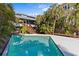 Outdoor swimming pool offers a relaxing retreat with views of the home's architectural details at 249 Shore Dr, Palm Harbor, FL 34683