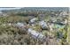 An aerial perspective showcases a complex with tennis courts surrounded by mature trees in a serene, residential setting at 2511 Dolly Bay Dr # 304, Palm Harbor, FL 34684
