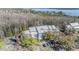 Aerial view of modern apartment complex surrounded by trees, offering a blend of nature and comfortable living near a lake at 2511 Dolly Bay Dr # 304, Palm Harbor, FL 34684