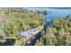 Aerial view of a charming lakefront home with a private pool and boat dock at 2511 Dolly Bay Dr # 304, Palm Harbor, FL 34684