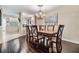 Dining room featuring a wood table and chandelier, adjacent to a bar area and kitchen at 2511 Dolly Bay Dr # 304, Palm Harbor, FL 34684